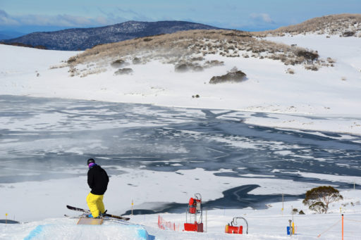 Skies cleared today at Falls Creek after 130cm+ of snow last week revealing ice caps on Rocky Valley Lake. More snow is tipped at the end of the week making for premium holiday skiing in the Alpine Resorts. Skier Jodan Cook slips a fun box on Falls Creek's Drover Terrain Park today.